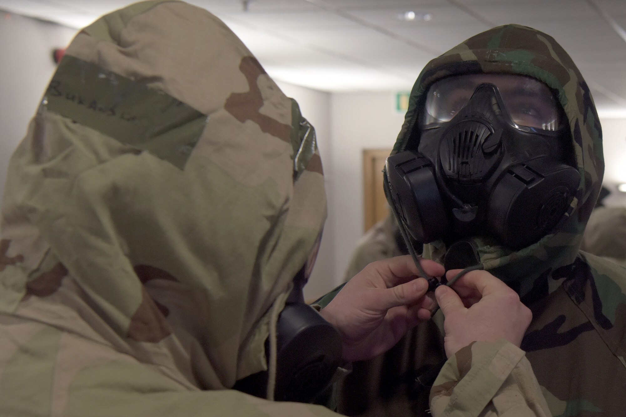 Master Sgt. Brian Bukauskas, 100th Operations Support Squardron air traffic control craftsman, performs a buddy check on Airman 1st Class Tyler Reisenhauer, 100th OSS air traffic control apprentice, during training for an upcoming exercise which will include agile combat concepts at RAF Mildenhall, England, Feb. 7, 2020. Agile Combat Employment is intended to help 100th Air Refueling Wing Airmen operate from different locations with varying levels of capacity and support. (U.S. Air Force photo by Senior Airman Benjamin Cooper)