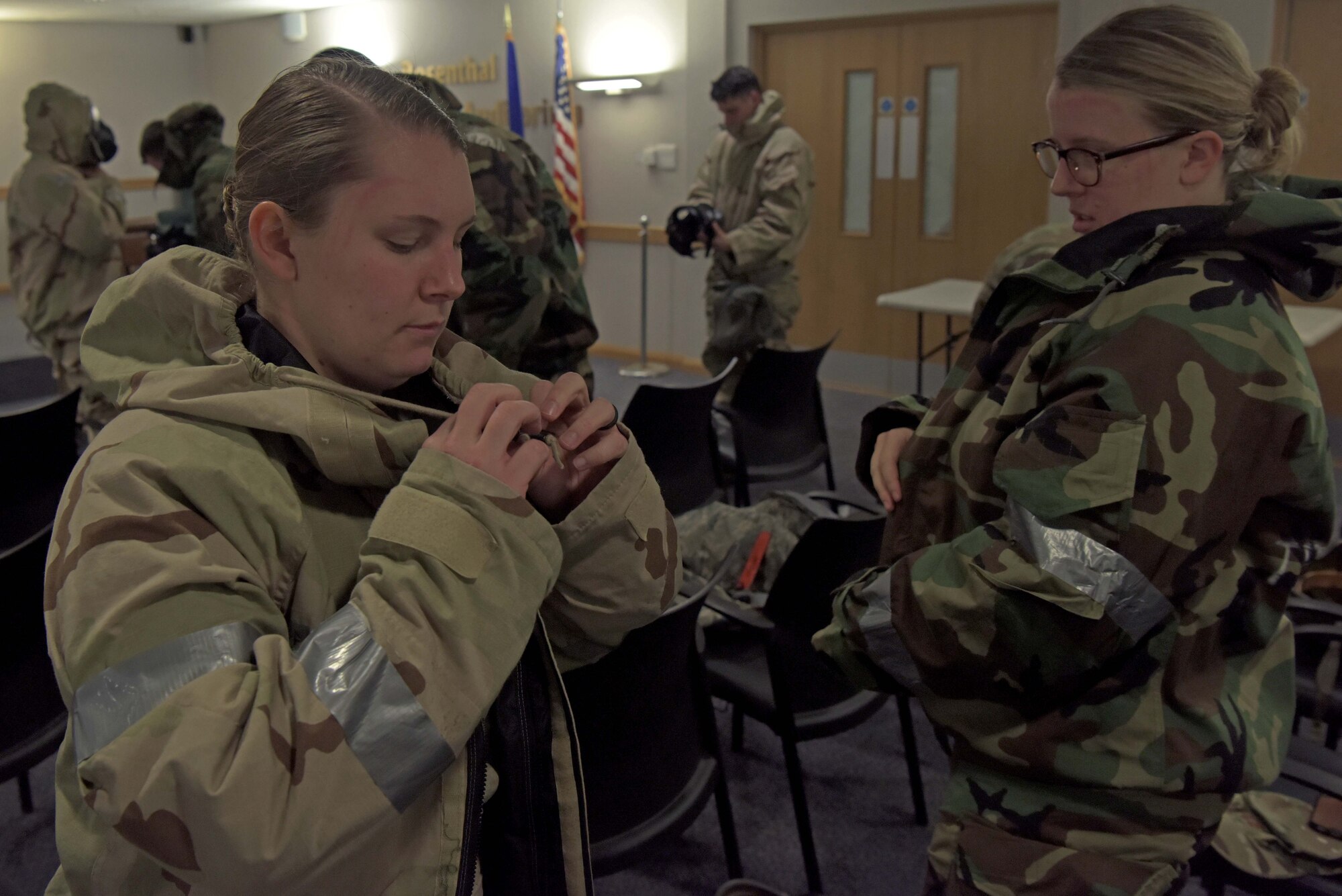 Senior Airman Alyssa Priest, 100th Logistics Readiness Squadron decentralized material support journeyman, and Capt. Monika Brohaugh, 100th Logistics Readiness Squadron material management flight commander, remove their chemical, biological, radiological, nuclear and explosive equipment after training for an upcoming exercise which will include agile combat concepts at RAF Mildenhall, England, Feb. 7, 2020. This training was an opportunity to incorporate agile combat starategies and ensure 100th Air Refueling Wing Airmen are ready at a moment’s notice to generate air power. (U.S. Air Force photo by Senior Airman Benjamin Cooper)