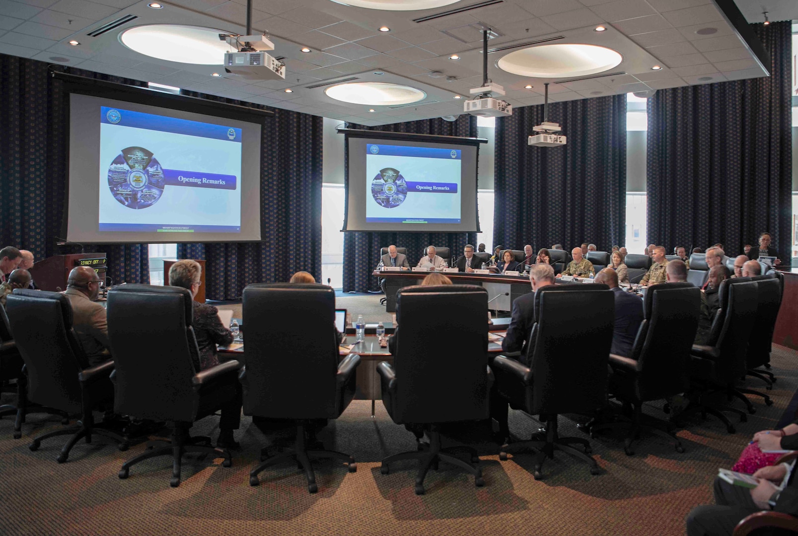 group gathers around a large meeting table