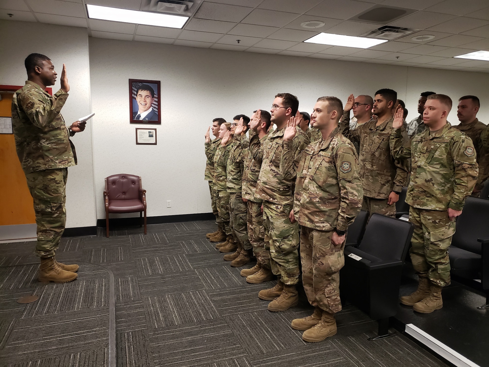 U.S. Air Force Chief Master Sgt. Kevin Richardson, 19th Maintenance Group superintendent, issues the Dedicated Crew Chief pledge during a formal induction ceremony.