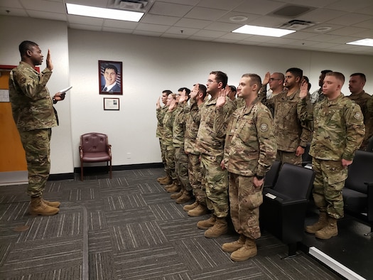 U.S. Air Force Chief Master Sgt. Kevin Richardson, 19th Maintenance Group superintendent, issues the Dedicated Crew Chief pledge during a formal induction ceremony.