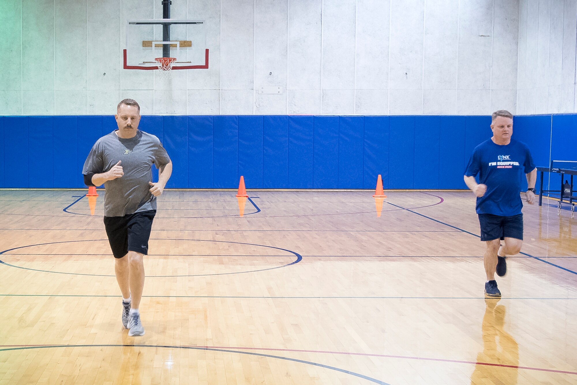 To the left, Master Sgt. Wesley Fletcher, 434th Aircraft Maintenance Squadron specialist flight chief, and Chief Master Sgt. Chad Weisend, 434th AMXS superintendent perform the new Air Force high aerobic multi-shuttle run. The 20 meter HAMR has the same correlation to predict V02 aerobic capacity as the 1.5-mile run, while also matching the age and gender scoring requirements. (U.S. Air Force photo/Master Sgt. Ben Mota)