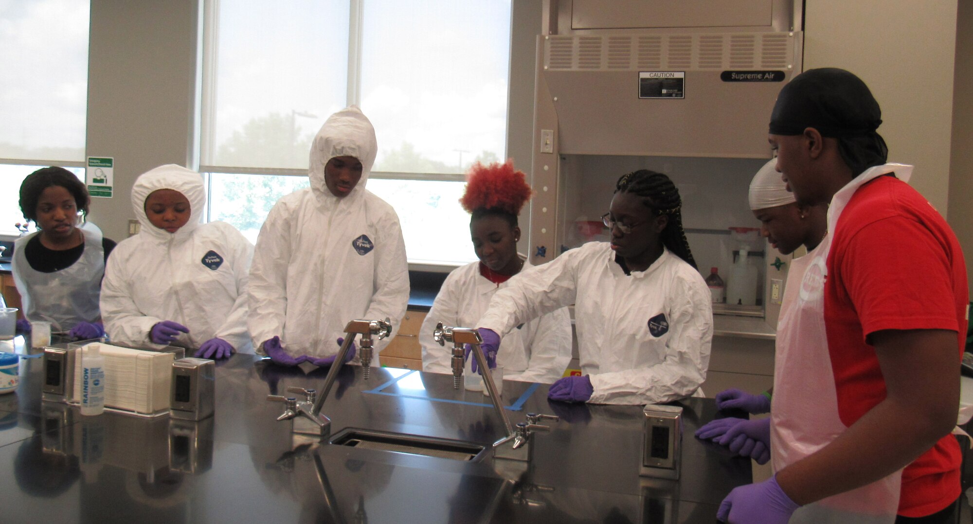 Students attending STEMversity work on a lab experiment with the help of Airman from the Air Force Technical Applications Center in Milledgeville, Ga. Each year, volunteers from the nuclear treaty monitoring center at Patrick Air Force Base, Fla., provide expertise in the fields of science, technology, engineering and math to the summer campers at Central Georgia Technical College. (U.S. Air Force photo by Stephanie Homitz)