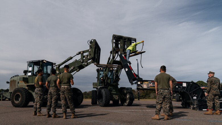 Following the offload of the Kalmar Rough Terrain Container Handler, U.S. Marines operate forklifts to deconstruct the platform it was transported with on Blount Island Command, Fla., Feb. 4, 2020. MPFEX 20 is a military exercise in which Marines and Sailors worked together to offload and process military equipment from a single MPF ship, the USNS Lopez (T-AK 3010). The exercise is a rehearsal of the Marines and Sailors’ ability to conduct safe, efficient offloads while in a tactical environment while working in close coordination with their 2nd and 6th Fleet counterparts to enhance the rapid and scalable deployment of naval expeditionary forces in European theaters. (U.S. Marine Corps photo by Cpl. Rachel K. Young-Porter)