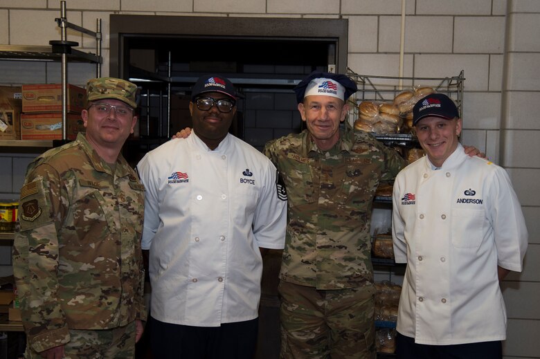 U.S. Air Force Gen. Mike Holmes, the commander of Air Combat Command, Chief Master Sgt. David Wade, the command chief of ACC, 2nd Lt. Ethan Anderson, 633rd Force Support Squadron officer in charge of food services, and Master Sgt. Charles Boyce, 633rd FSS non-commission officer in charge of food services, pose for a photo at Joint Base Langley-Eustis, Virginia, Feb. 7, 2020.