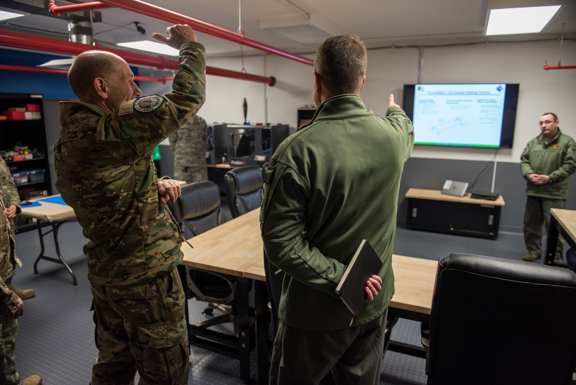 U.S. Air Force Gen. Mike Holmes, commander of Air Combat Command, speaks about the 1st Fighter Wing’s newly opened innovation lab with Col. David Lopez, 1st FW commander, at Joint Base Langley-Eustis, Virginia, Feb. 6, 2020.