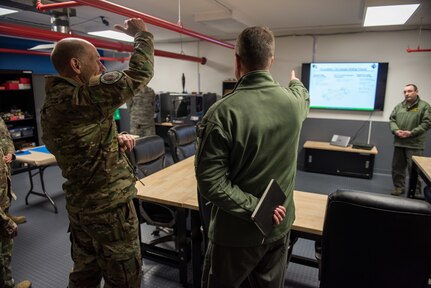 U.S. Air Force Gen. Mike Holmes, commander of Air Combat Command, speaks about the 1st Fighter Wing’s newly opened innovation lab with Col. David Lopez, 1st FW commander, at Joint Base Langley-Eustis, Virginia, Feb. 6, 2020.