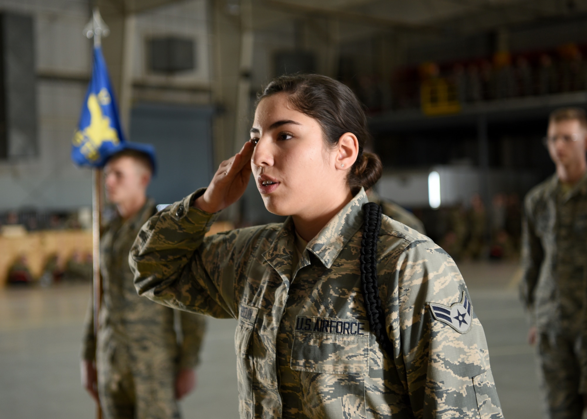 U.S. Air Force Airman 1st Class Walker Arroquin, 315th Training Squadron student, report salutes before commanding her flight at the 17th Training Group Drill Competition inside the Louis F. Garland Department of Defense Fire Academy High Bay on Goodfellow Air Force Base, Texas, Feb. 7, 2020. As the person in charge, Arroquin formally reports for the whole formation prior to competing. (U.S. Air Force photo by Airman 1st Class Abbey Rieves)