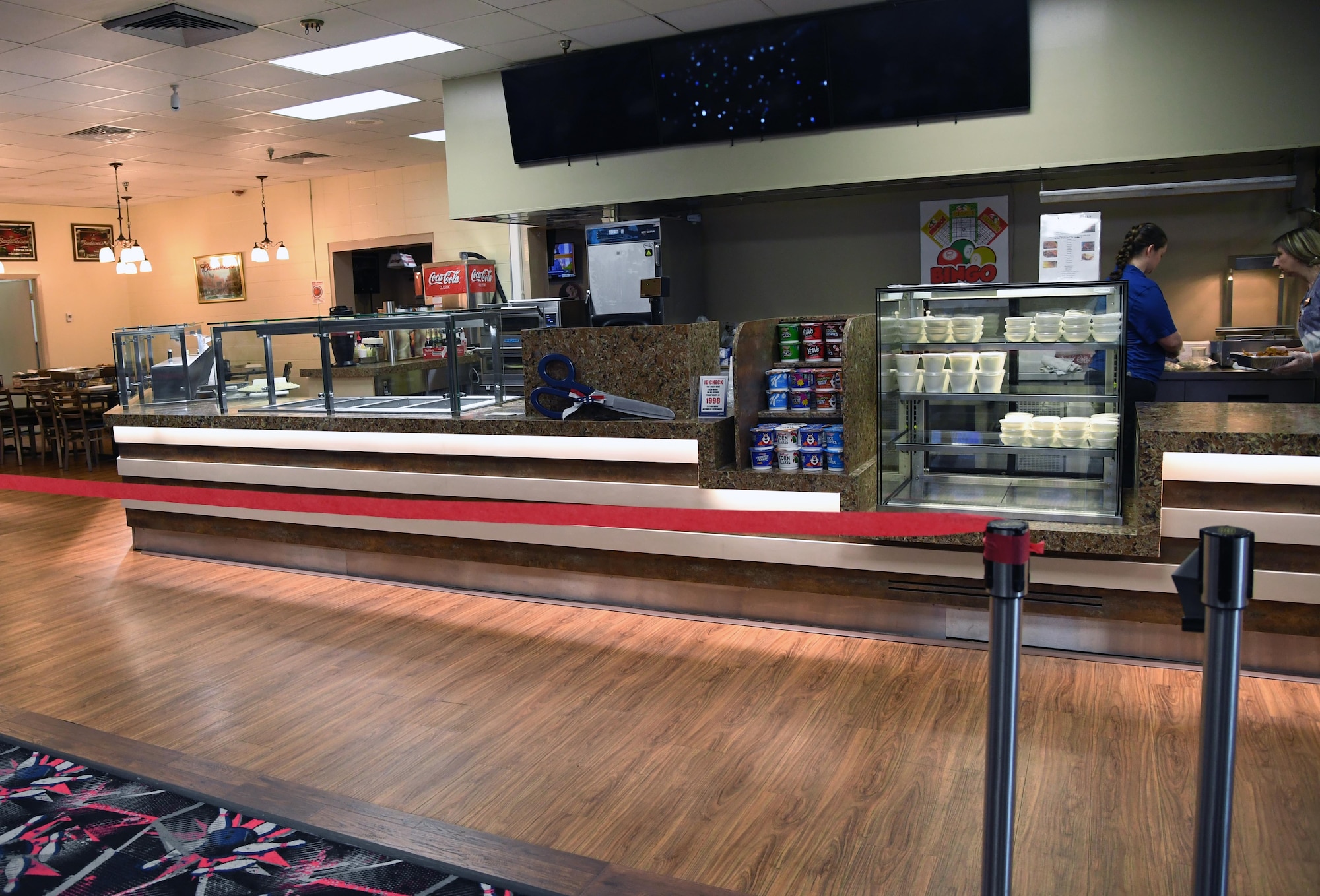 A ribbon is displayed in front of the newly renovated snack bar during the grand re-opening of the Gaude Lanes Bowling Center at Keesler Air Force Base, Mississippi, Feb. 7, 2020. Renovations in the 11th Frame Cafe includes more space, new furniture and light fixtures and the addition of a grab-n-go section. (U.S. Air Force photo by Kemberly Groue)