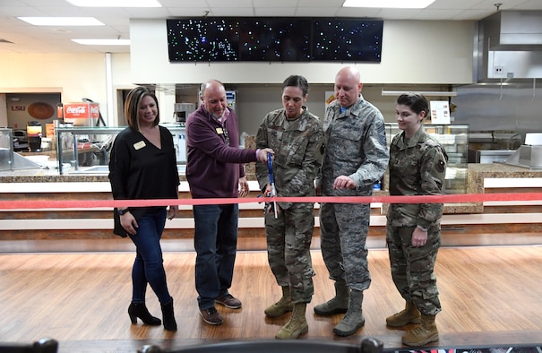 U.S. Air Force Col. Heather Blackwell, 81st Training Wing commander, and Chief Master Sgt. David Pizzuto, 81st TRW command chief, is joined by members of the 81st Force Support Squadron in a ribbon-cutting ceremony during the grand re-opening of the Gaude Lanes Bowling Center at Keesler Air Force Base, Mississippi, Feb. 7, 2020. Renovations in the 11th Frame Cafe includes more space, new furniture and light fixtures and the addition of a grab-n-go section. (U.S. Air Force photo by Kemberly Groue)