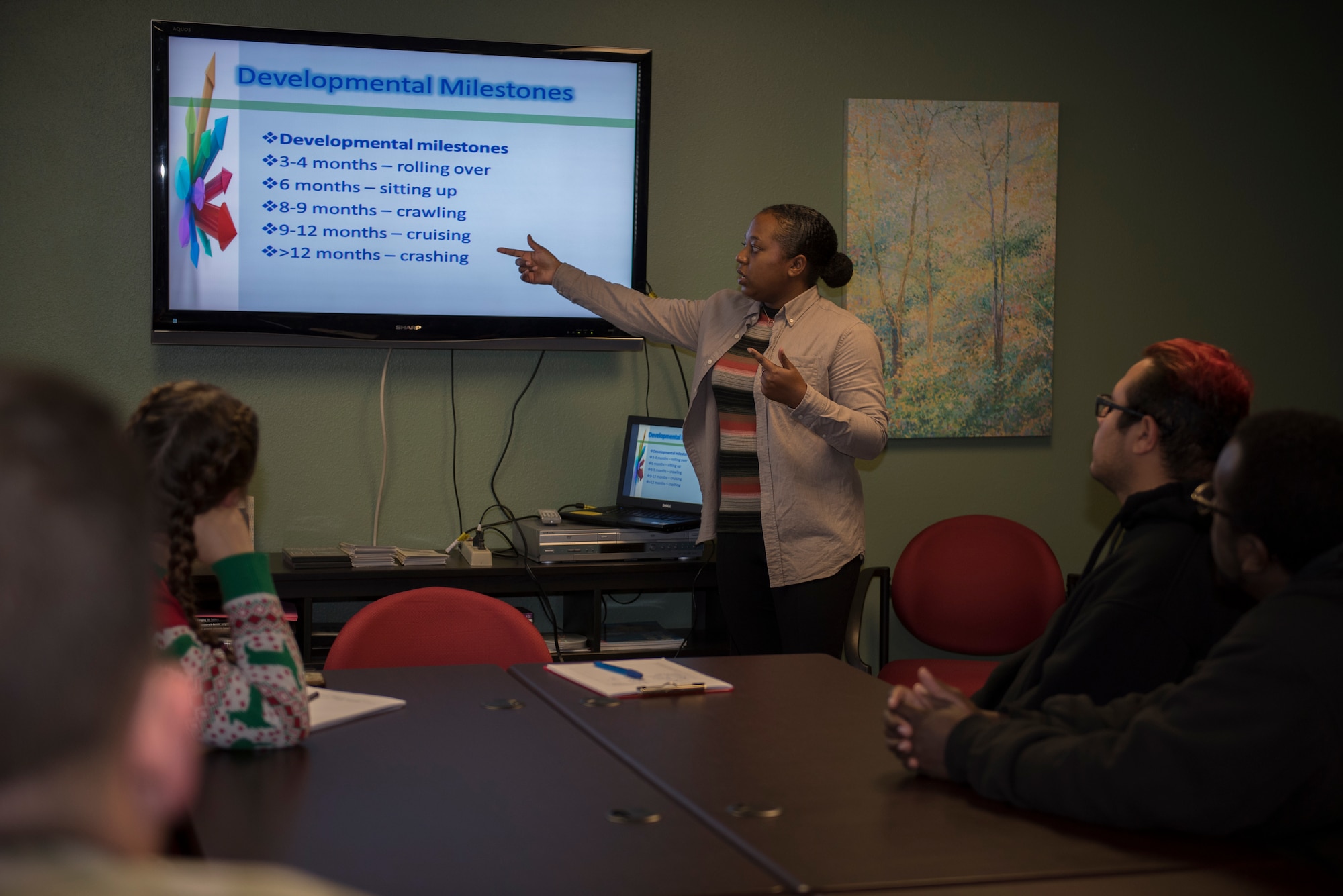 Kristin Criner, center, 60th Medical Operations Squadron family advocacy outreach manager, teaches a child abuse recognition and reporting class Dec. 18, 2019, at Travis Air Force Base, California. The class teaches participants how to identify child abuse and what actions to take. (U.S. Air Force photo by Airman 1st Class Cameron Otte)