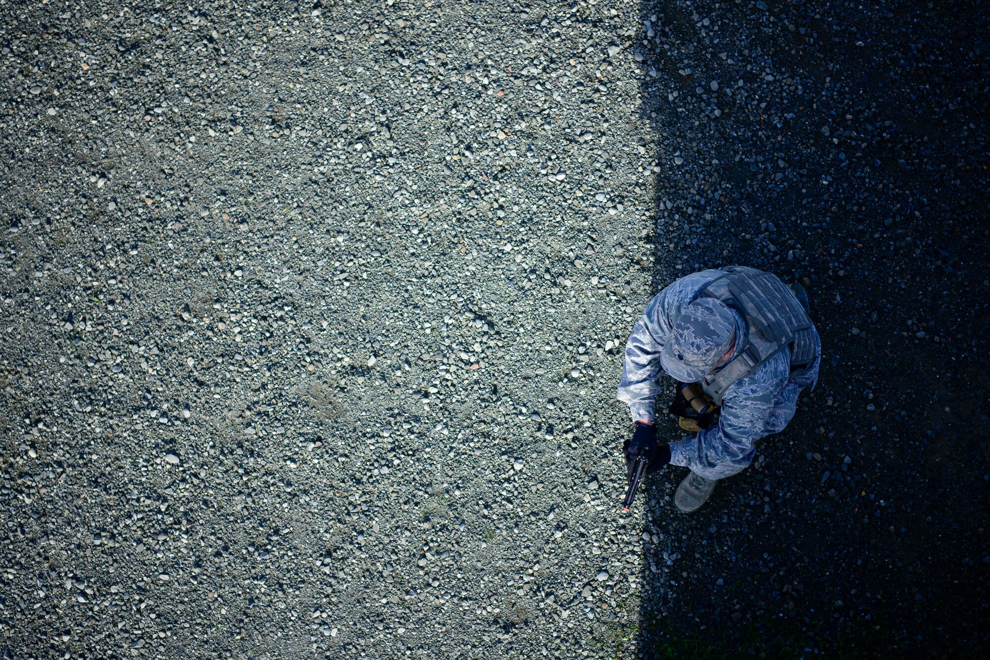 U.S. Air Force Lt. Col. David Hernandez, 43rd Aeromedical Evacuation Squadron Detachment 1 chief nurse, checks for threats around a wall during a combat training scenario Jan. 31, 2020, at Travis Air Force Base, California. Airmen participated in a three-day tactical combat casualty care course that trained aeromedical personnel to manage effective healthcare during different combat situations. (U.S. Air Force photo by Nicholas Pilch)