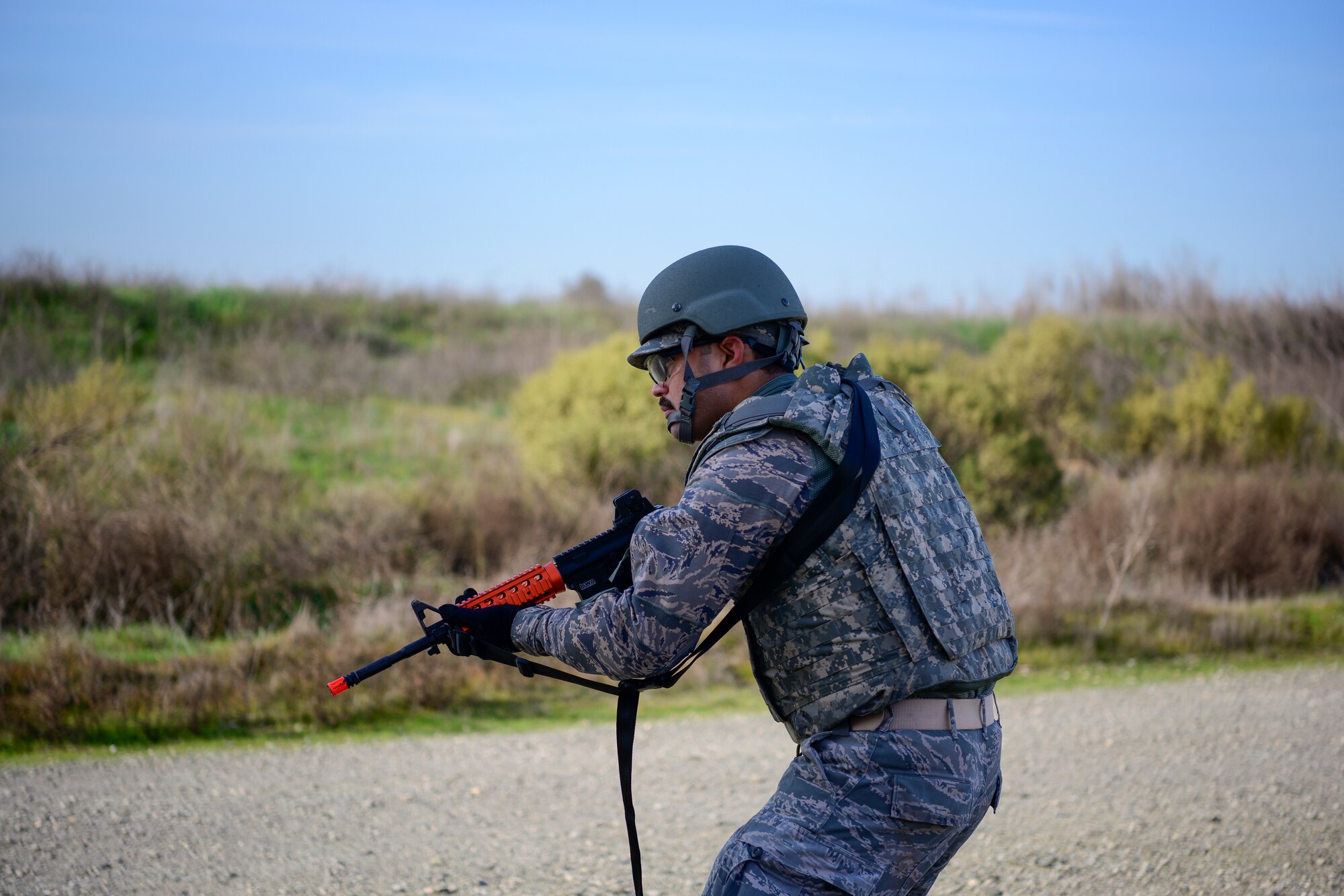 U.S. Air Force Tech. Sgt. Roger Toliver, 43rd Aeromedical Evacuation Squadron Detachment 1 radio frequency transmission systems technician, scans for threats during a combat training scenario Jan. 31, 2020, at Travis Air Force Base, California. Airmen participated in a three-day tactical combat casualty care course that trained aeromedical personnel to manage effective healthcare during different combat situations. (U.S. Air Force photo by Nicholas Pilch)