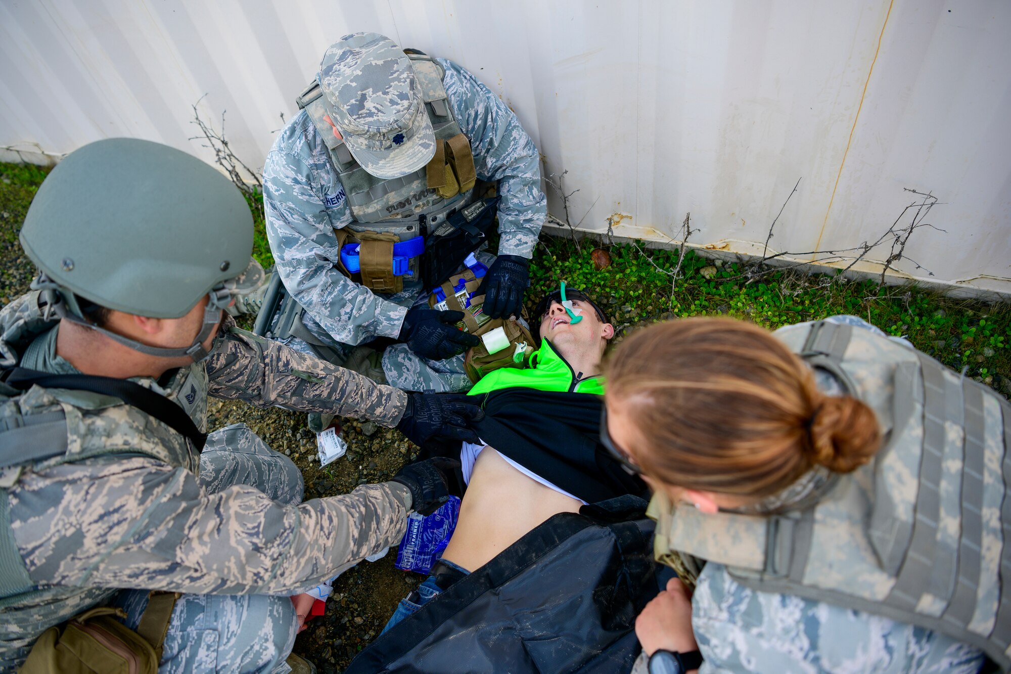 U.S. Air Force Lt. Col. David Hernandez, center, 43rd Aeromedical Evacuation Squadron Detachment 1 chief nurse, Staff Sgt. Cali Lutz, right, 43rd AES Detachment 1 AE technician, and Tech. Sgt. Roger Toliver, 43rd AES Detachment 1 radio frequency transmission systems technician, perform simulated life-saving healthcare to a moulage victim, during a combat training scenario Jan. 31, 2020, at Travis Air Force Base, California. Airmen participated in a three-day tactical combat casualty care course that trained aeromedical personnel to manage effective healthcare during different combat situations. (U.S. Air Force photo by Nicholas Pilch)