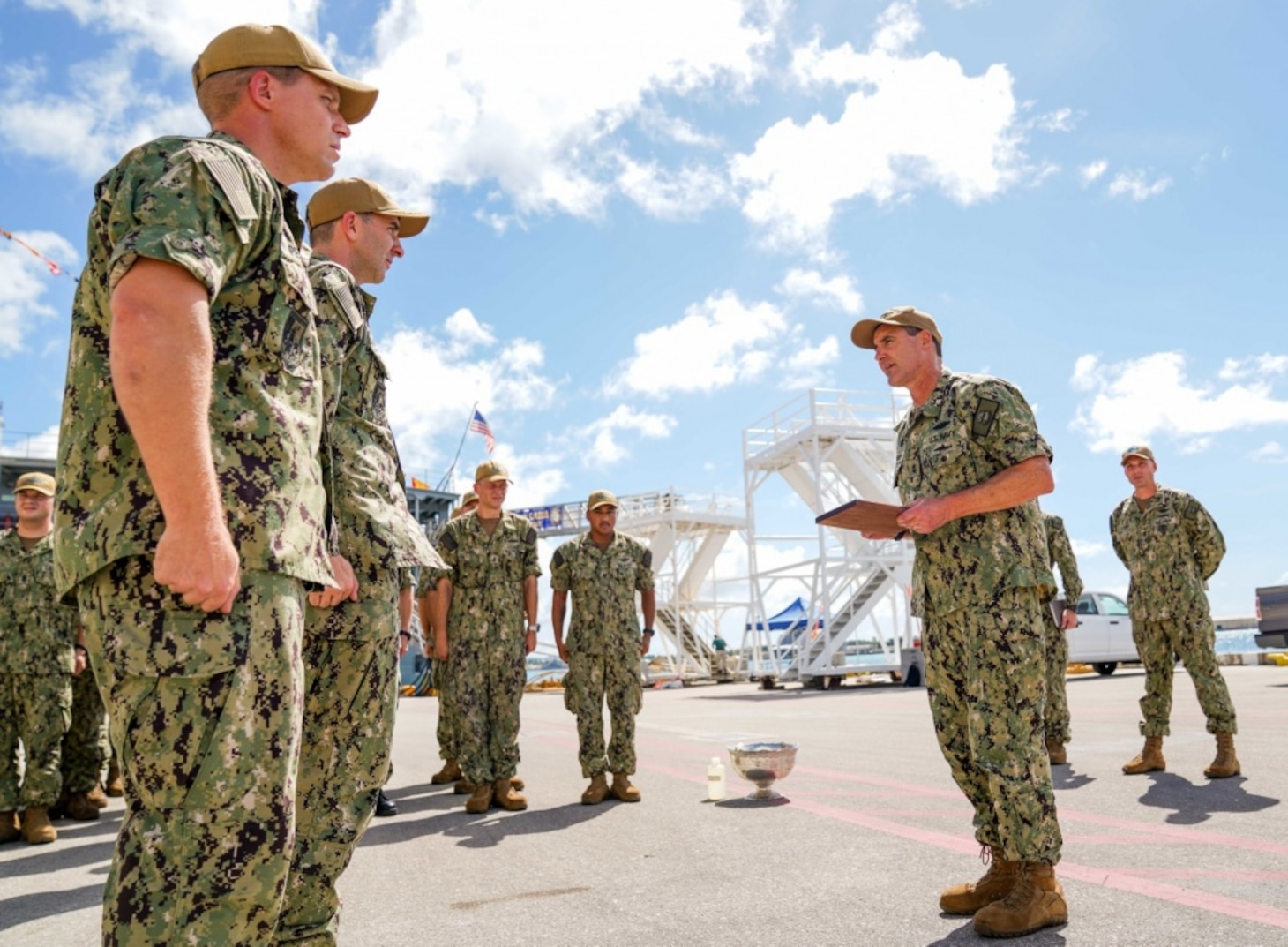 SANTA RITA, Guam (Feb. 7, 2020) Rear Adm. Blake Converse, Commander of Submarine Force, U.S. Pacific Fleet, presents the Battle “E” Award to Cmdr. Steven Lawrence, commanding officer of the Los Angeles-class fast attack submarine USS Oklahoma City (SSN 723), and his crew on the pier at Apra Harbor, Guam. Oklahoma City is one of four forward-deployed submarines assigned to Commander, Submarine Squadron Fifteen out of Apra Harbor, Guam.