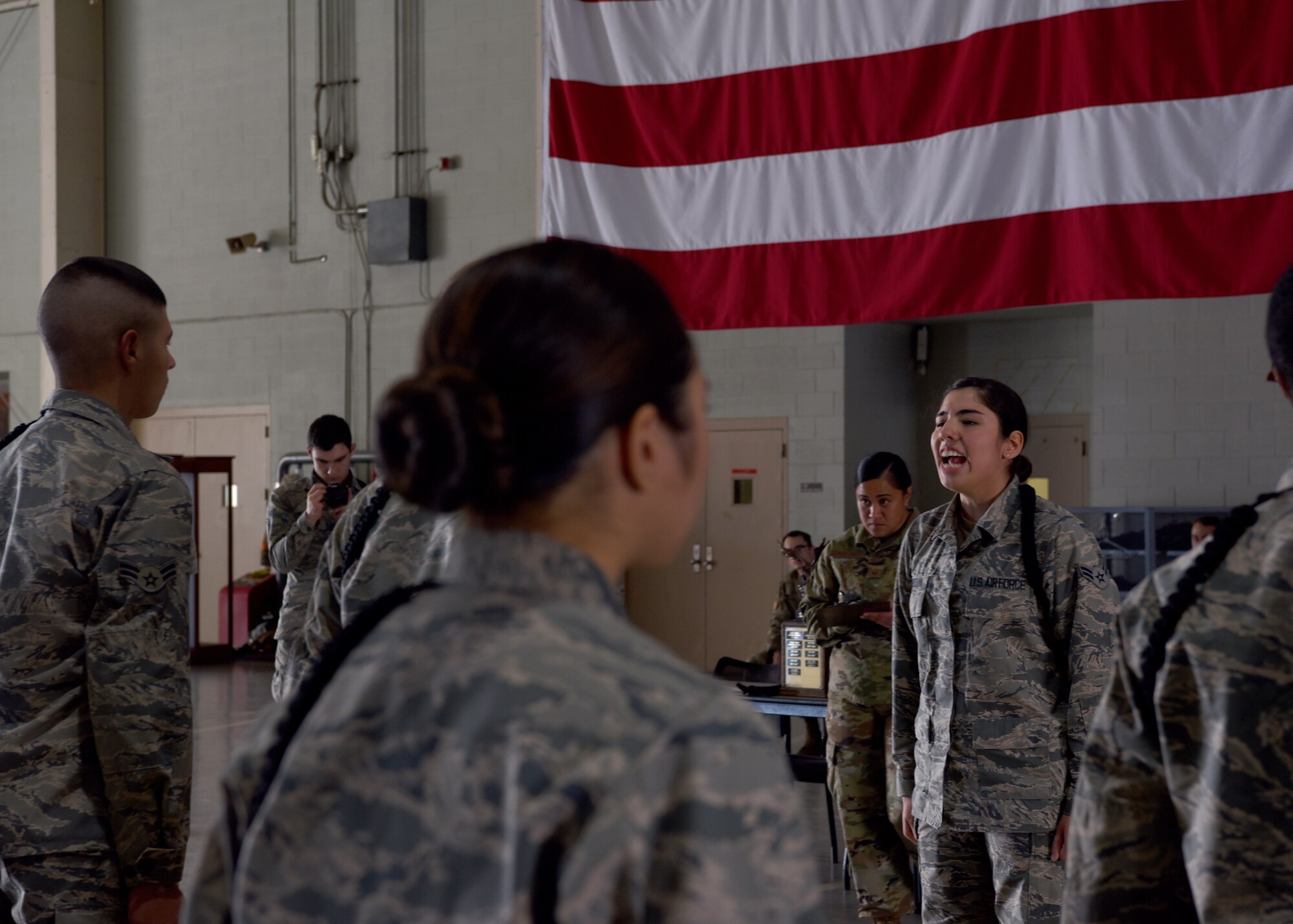 U.S. Air Force Airman 1st Class Walker Arroquin, 315th Training Squadron student, delivers the command of execution, which puts her flight to the position of attention during the 17th Training Group Drill Competition at the Louis F. Garland Department of Defense Fire Academy High Bay on Goodfellow Air Force Base, Texas, Feb. 7, 2020. Per AFMAN 36-2203, the tone, cadence, and snap in which commands are given affects how willing, correct, and immediate the response will be. (U.S. Air Force photo by Airman 1st Class Abbey Rieves)