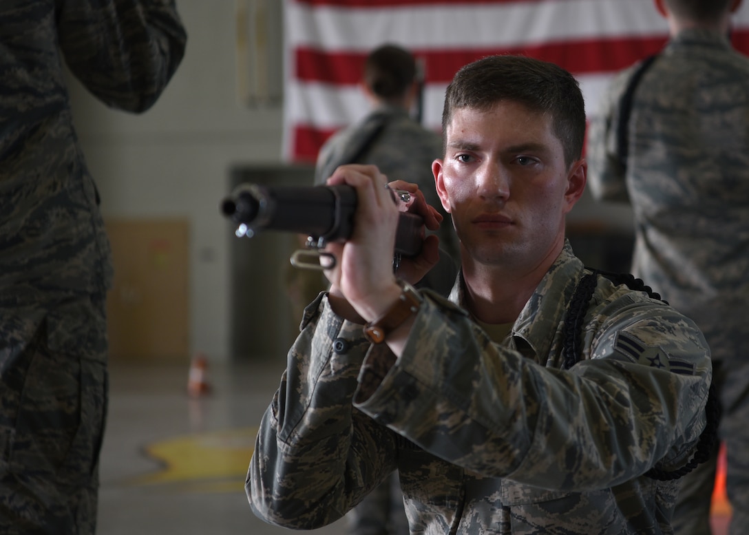 U.S. Air Force Airman 1st Class Nicolas Smaracheck, 315th Training Squadron student, performs an exhibition drill routine during the 17th Training Group Drill Competition at the Louis F. Garland Department of Defense Fire Academy High Bay on Goodfellow Air Force Base, Texas, Feb. 7, 2020. Exhibition drill rifle routines were judged on creativity, innovation and dedication. (U.S. Air Force photo by Airman 1st Class Abbey Rieves)