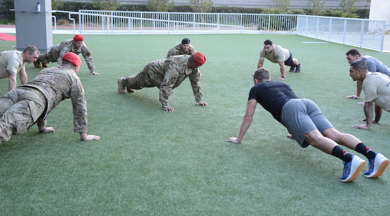 Special warfare Airmen perform memorial push-ups, alongside Ultimate Fighting Championship fighters Forrest Griffin and Stephen Thompson during a fliming at the UFC Performance Institue in Las Vegas, Nevada.