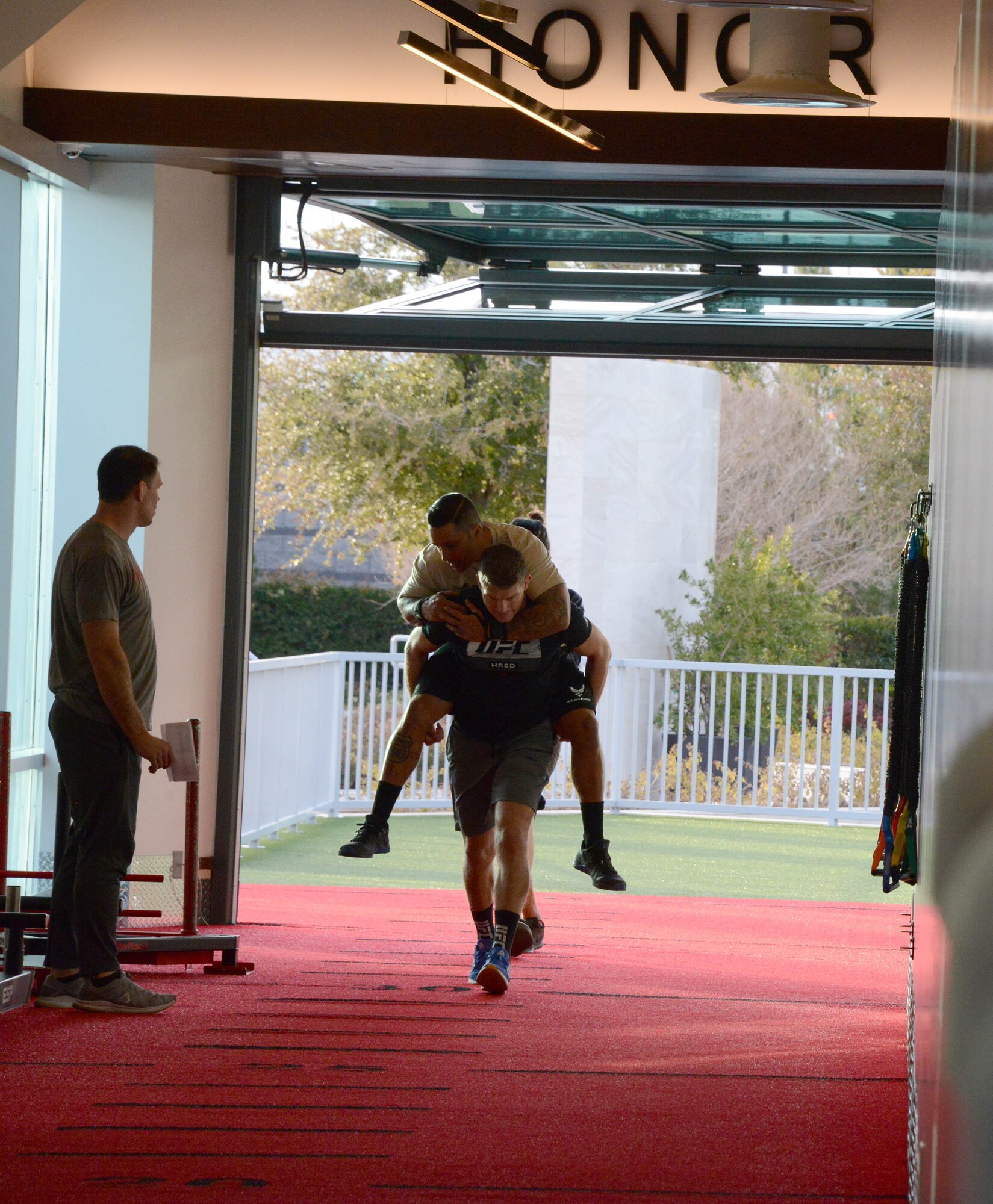 A special warfare Airman and Ultimate Fighting Championship fighter Stephen Thompson conduct a rigorous workout as UFC fighter Forrest Griffin looks on during a video production at the UFC Performance Institute in Las Vegas, Nevada.