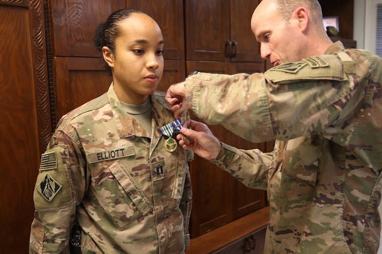 Cpt. Jordan Elliott is recognized with the Joint Service Commendation Medal and the NATO medal from Afghanistan District Commander, COL Chris Becking, as she redeploys from a successful tour with USACE.