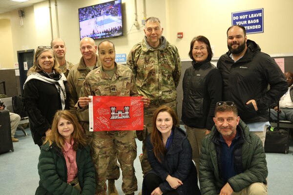 Members from the Programs and Project Management Division caught up with Cpt. Elliott at the terminal to present her with a few mementos of her time in theater.