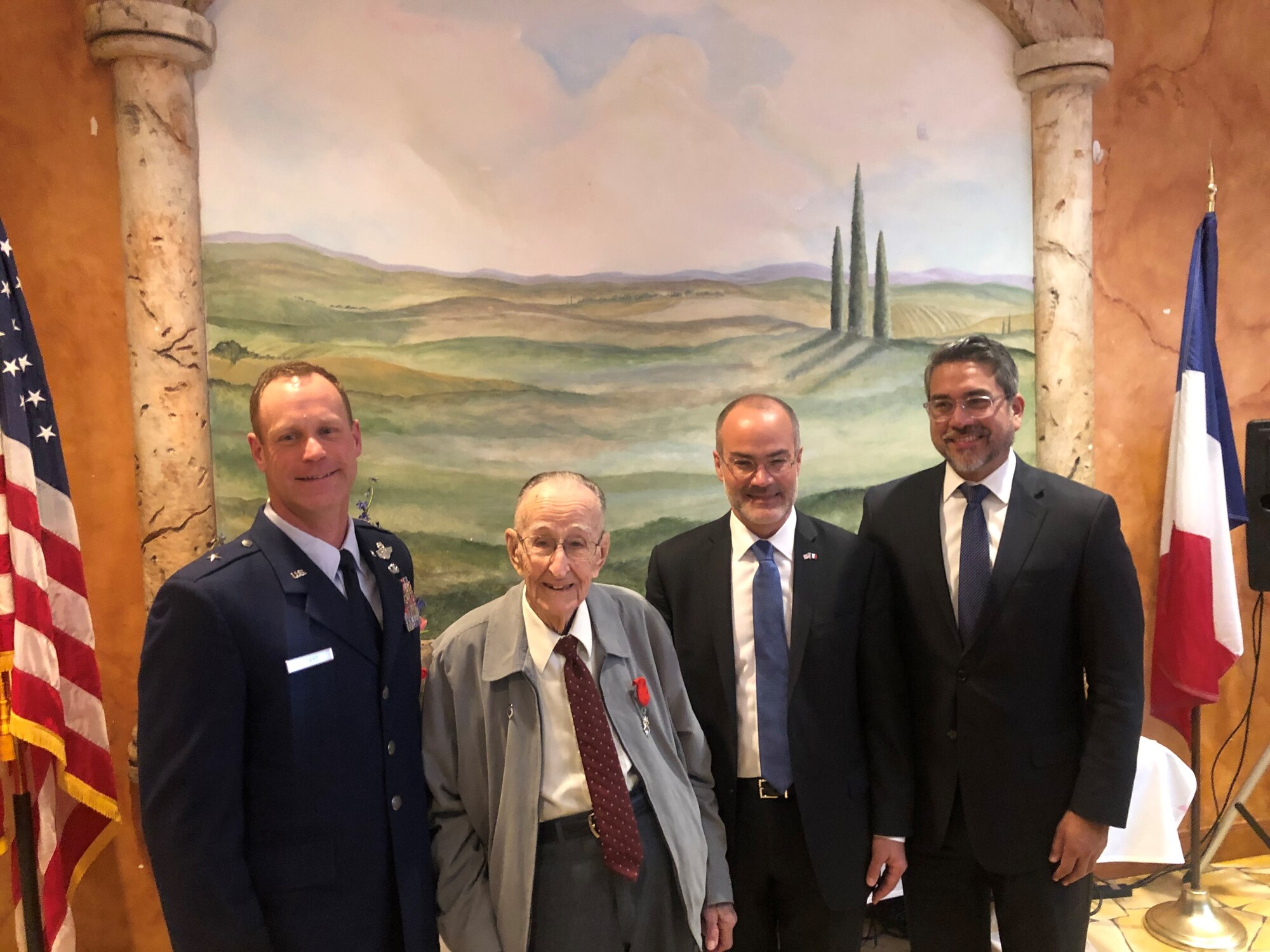 Long-time San Antonio resident and United States Army Air Corps World War II veteran Roland Dullnig (second from left) stands with U.S. Air Force Brig. Gen. James Sears (left), Air Education and Training Command director of plans, programs and requirements, as well as the Consul General of France in Houston, Alexis Andres (second from right) and Robert Travino (right), San Antonio City Councilman District One, after being presented the French Legion of Honor medal in a ceremony which included family and friends in San Antonio, Texas, Feb. 8, 2020.  The French Legion of Honor is a prestigious medal and has been recently awarded by the people of France to American Veterans who fought for the liberation of France during World War II. (U.S. Air Force photo / Maj. Kim Garbett)