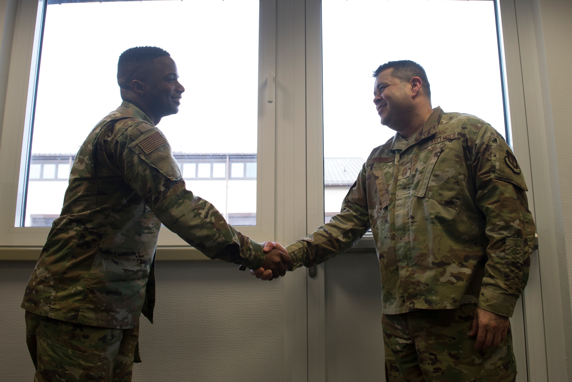 U.S. Air Force Chief Master Sgt. Ernesto Rendon, 86th Airlift Wing command chief, right, coins Tech. Sgt. Marcus Bias, 86th AW equal opportunity specialist, at Ramstein Air Base, Germany, Jan. 30, 2020. Together, Bias and his team of instructors executed 145 classes, resulting in an equal opportunity complaint reduction of 35 percent.