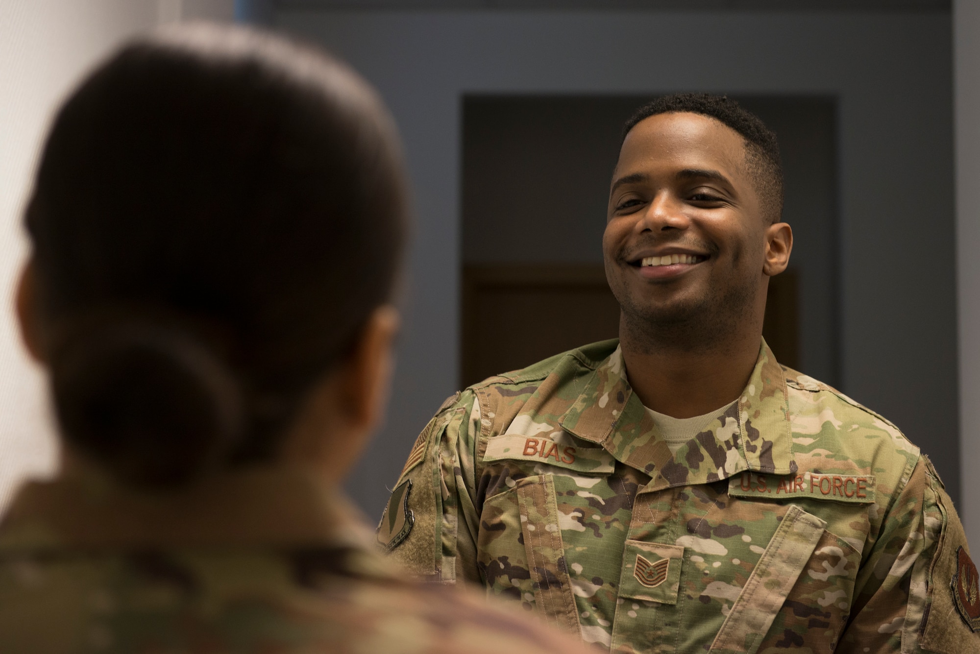 U.S. Air Force Tech. Sgt. Marcus Bias, 86th Airlift Wing equal opportunity specialist, speaks with a coworker at Ramstein Air Base, Germany, Feb. 6, 2020. The 86th AW Equal Opportunity office supports all active duty members, civilian employees and their family members across three wings including the 3rd Air Force, NATO and United States Air Forces in Europe, with enhancing cooperation in the workplace and advancing professional growth.