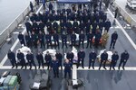 Coast Guardsmen assemble before preparing bails of cocaine to be offloaded from the Coast Guard Cutter Munro.