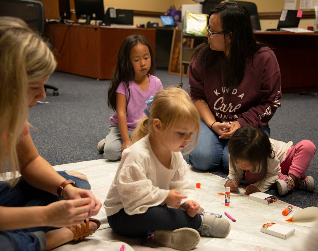 Children and their parents work on crafts during story time at the library, Feb. 5, 2020, Tyndall Air Force Base, Florida. Story time is held Wednesday mornings at 10:30 a.m. (U.S. Air Force photo by 2nd Lt. Kayla Fitzgerald)