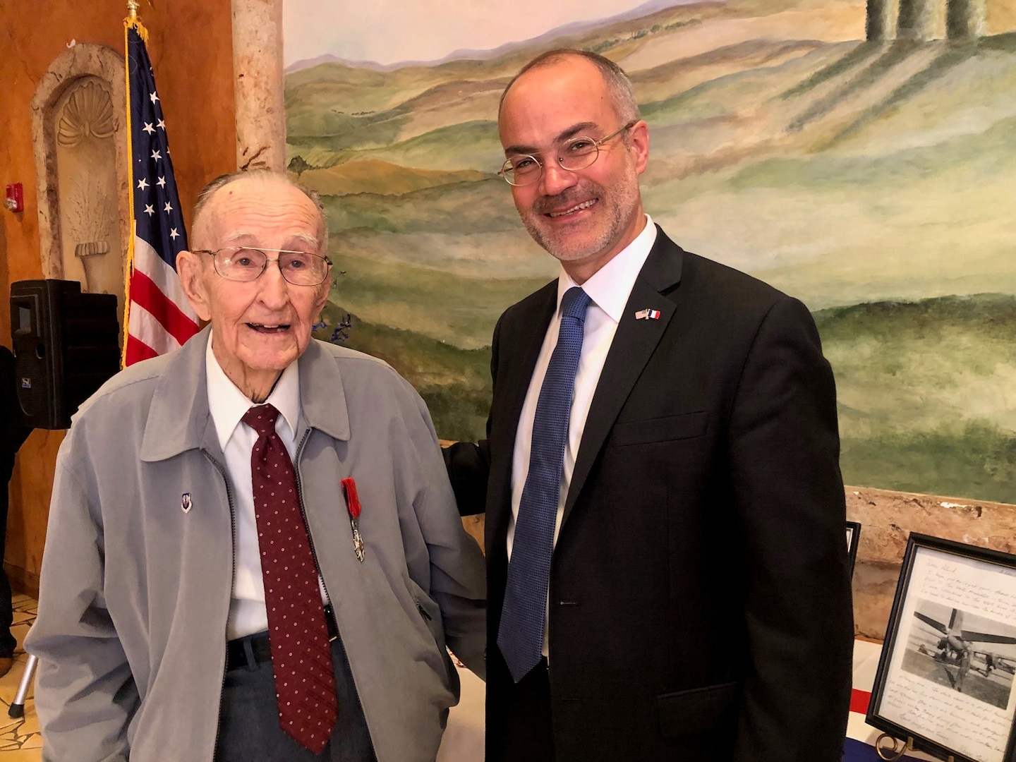 Long-time San Antonio resident and United States Army Air Corps World War II veteran Roland Dullnig (left) stands with the Consul General of France in Houston, Alexis Andres, after being presented the French Legion of Honor medal in a ceremony which included family and friends in San Antonio, Texas, Feb. 8, 2020.  The French Legion of Honor is a prestigious medal and has been recently awarded by the people of France to American Veterans who fought for the liberation of France during World War II. (U.S. Air Force photo / Maj. Kim Garbett)