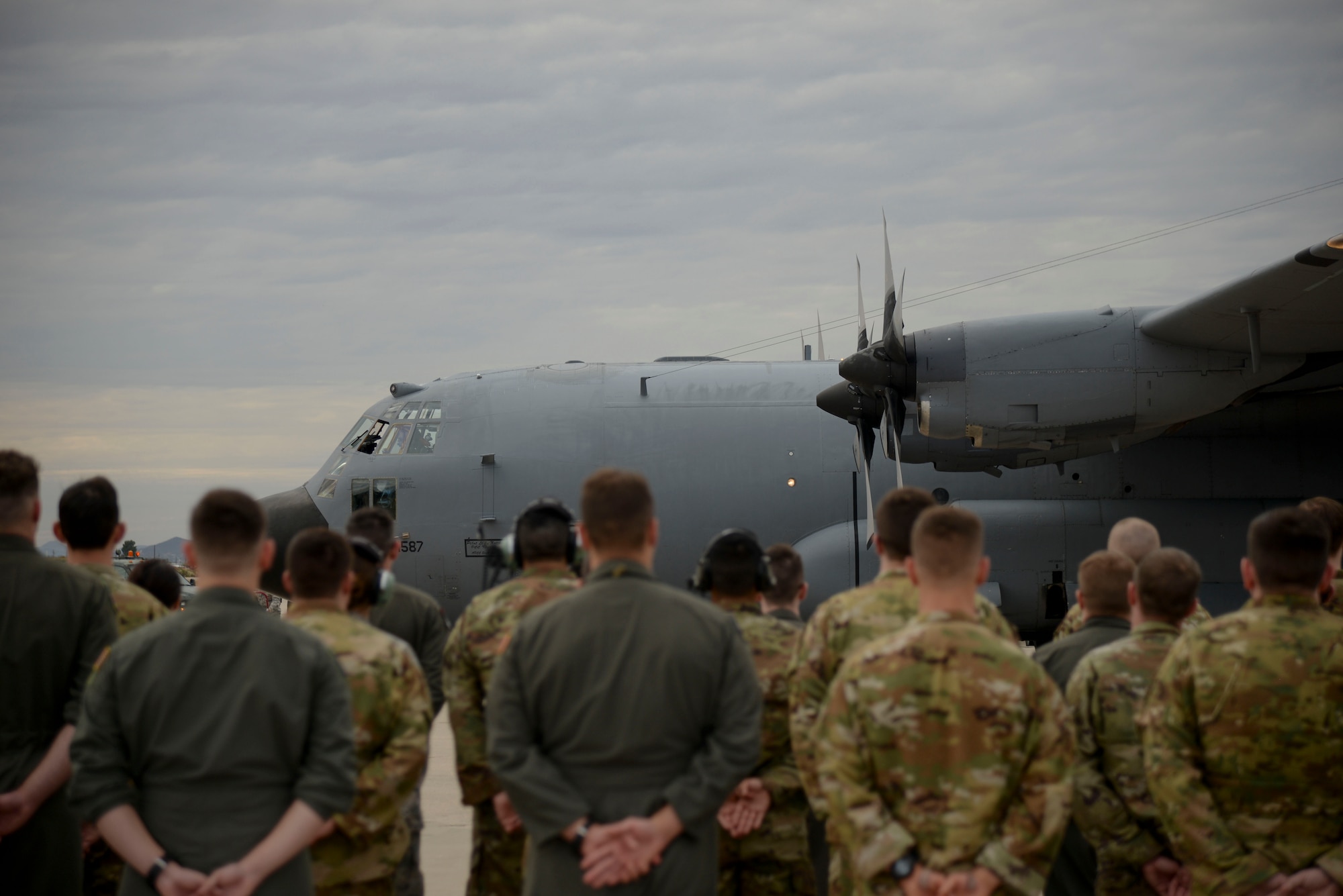 Airmen stand in formation next to an EC-130H