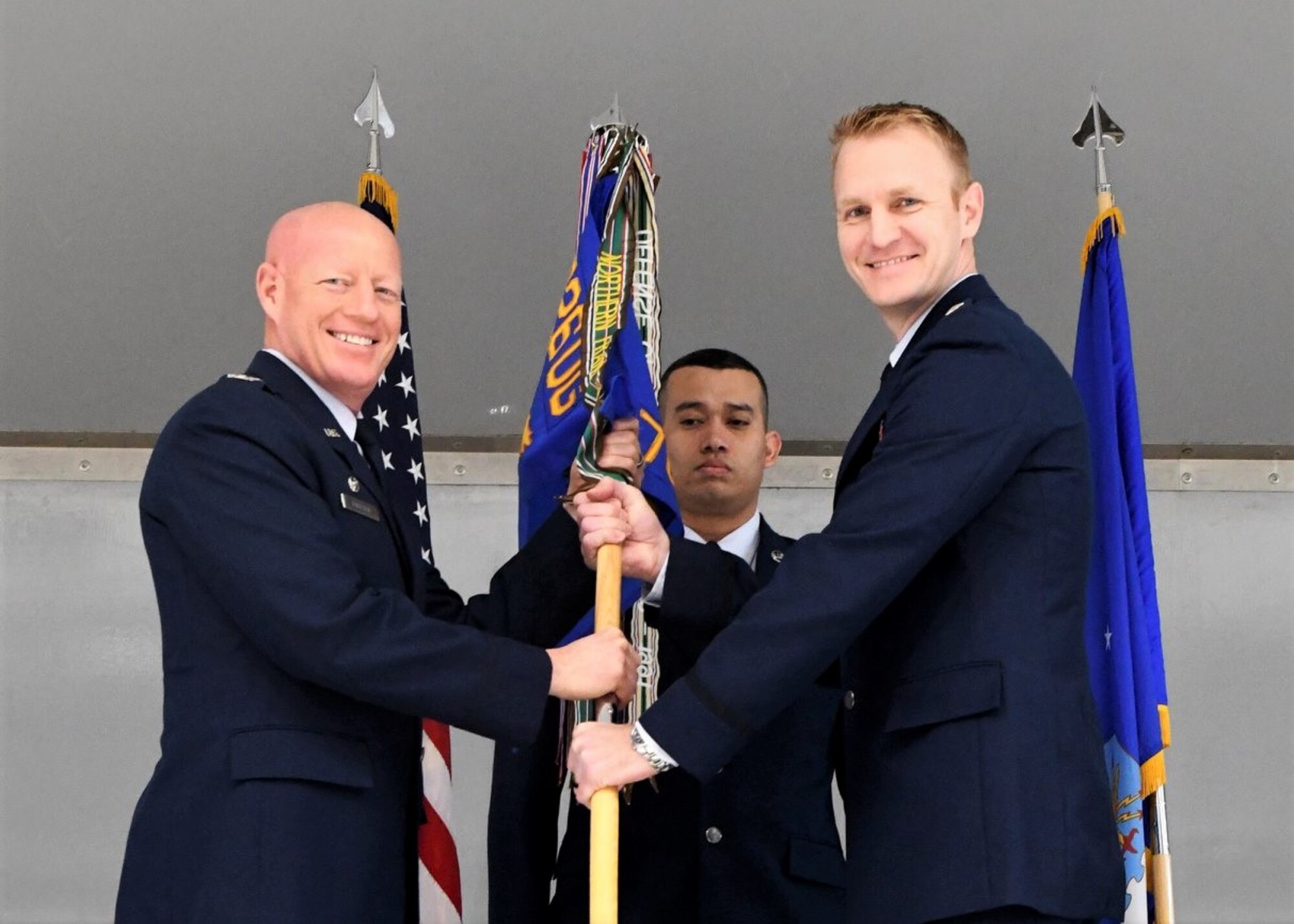 Col. Todd Tobergte, 926th Operations Group commander, hands the 706th Fighter Squadron guidon to Lt. Col. Michael Fisher, 706th FS commander, during a change of command ceremony held Jan. 31, 2020, at Nellis Air Force Base, Nev. The 706th FS seamlessly integrates Reserve personnel into the United States Air Force Warfare Center’s test and training mission.