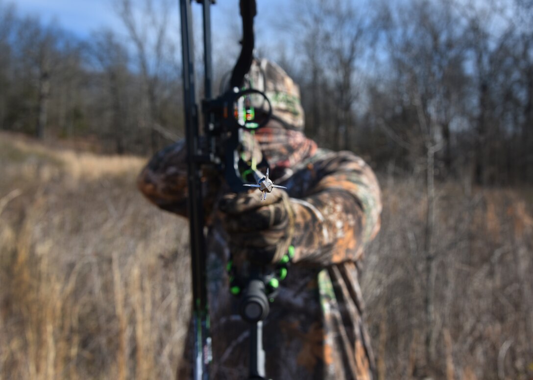 An airman poses for a photo in the words.