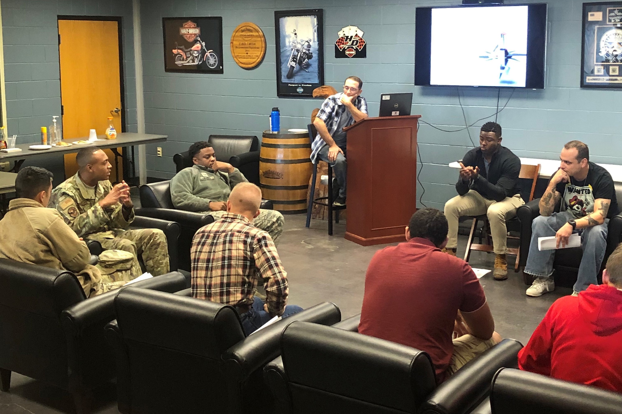 Picture shows members of the 116th and 461st Maintenance Squadrons sitting together in a room in a discussion.