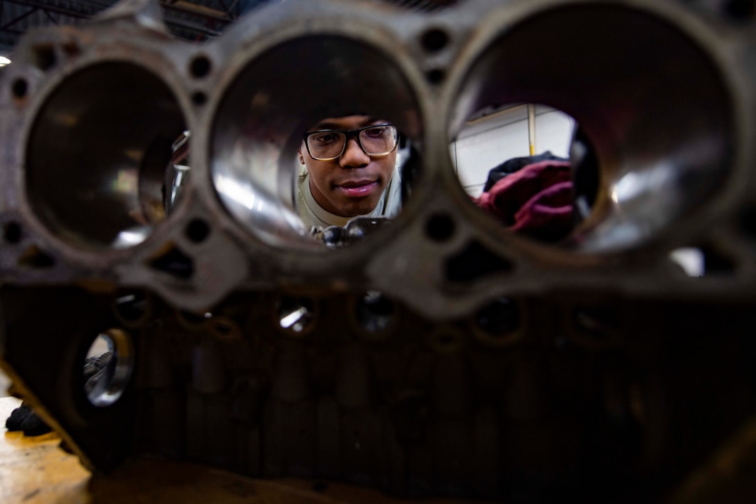 An airman seen through a small hole in an engine.