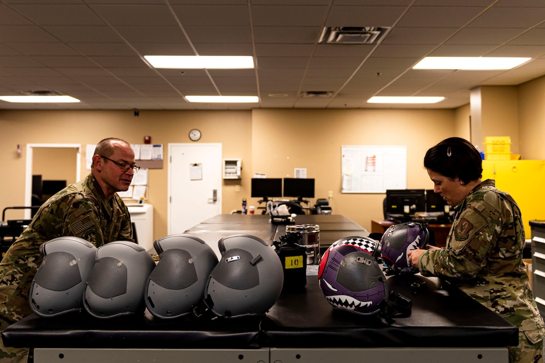 Photo of Airmen discuss mission details.