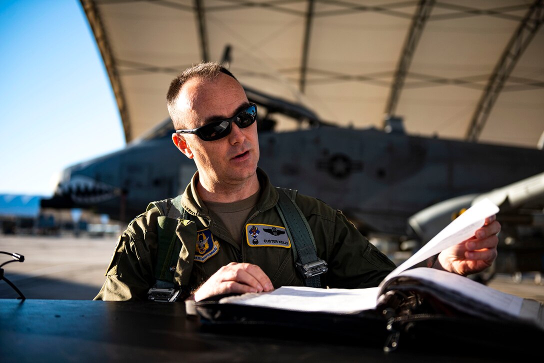 Photo of pilot examining aircraft forms.