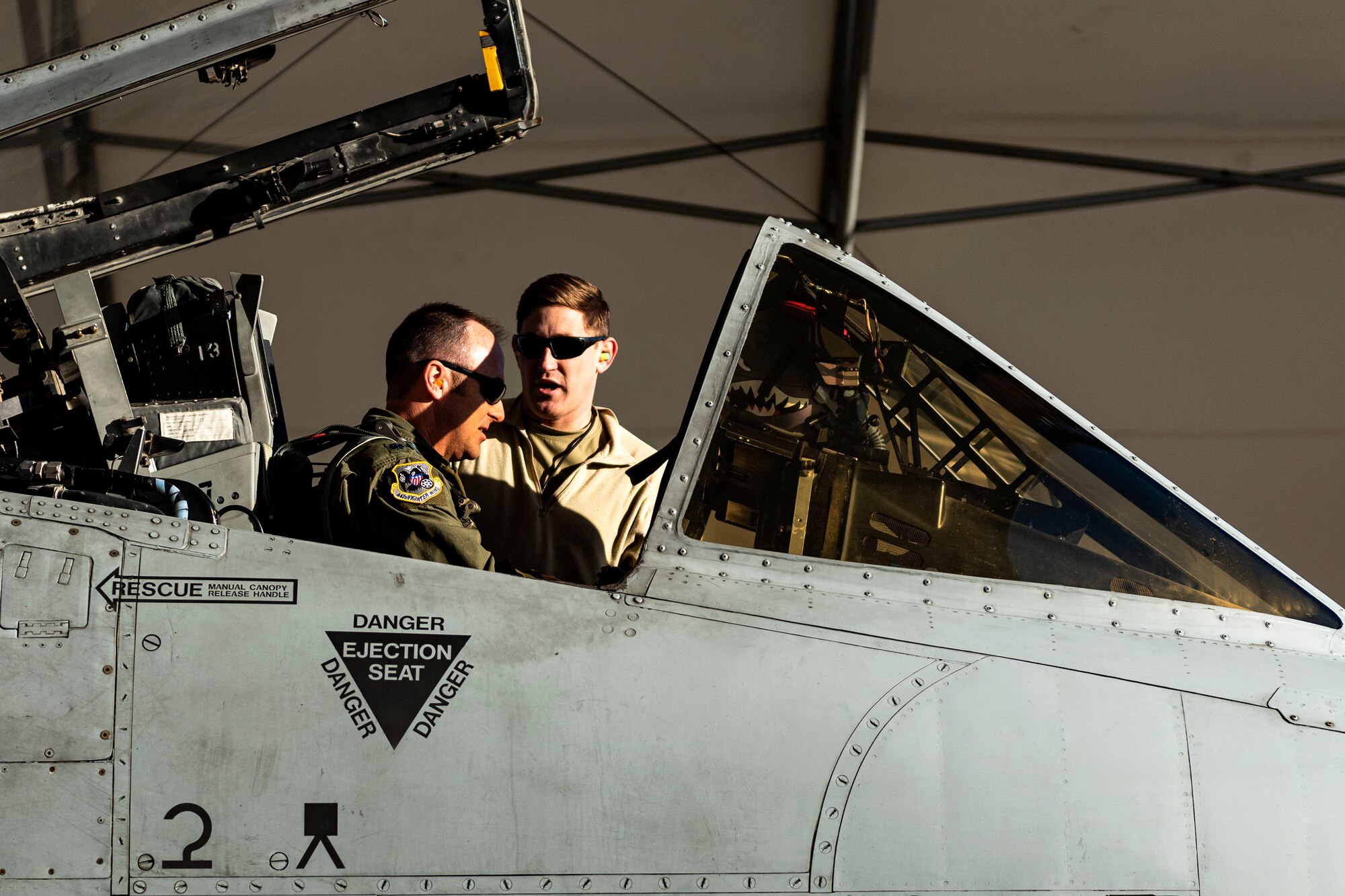 Photo of Airmen discussing aircraft details.