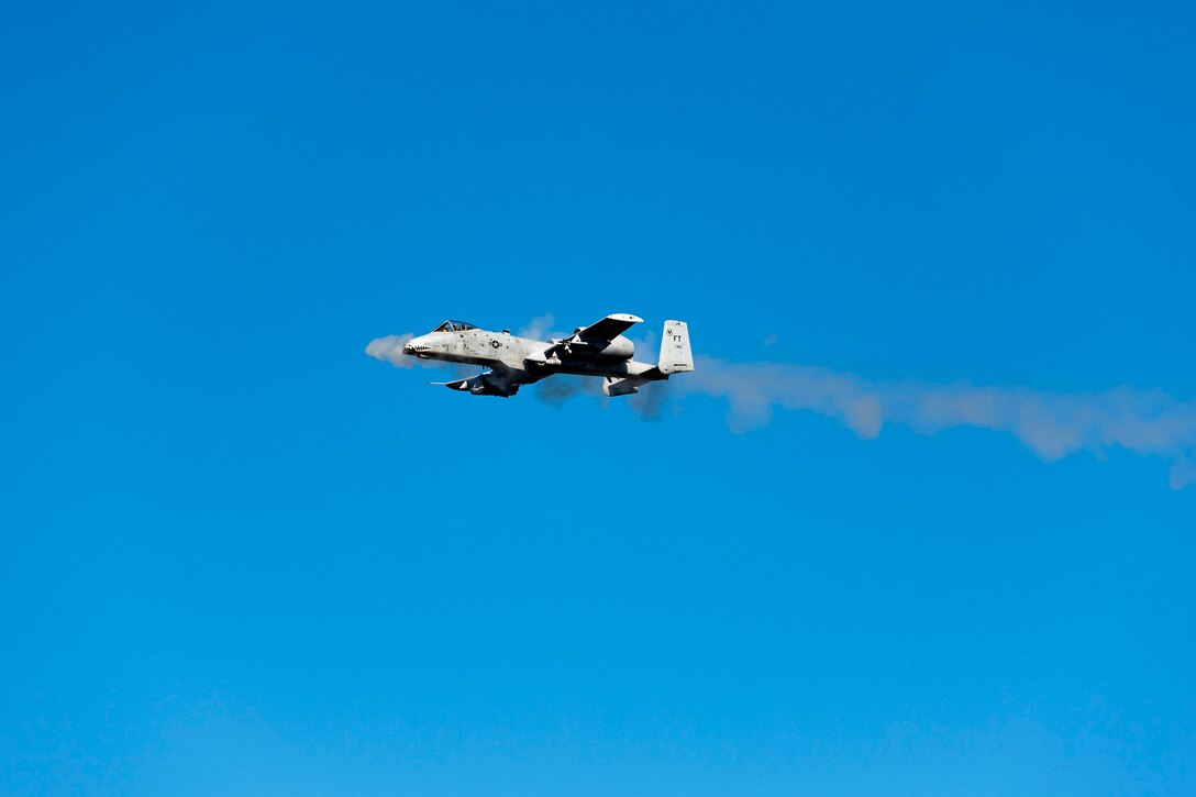 Photo of an A-10C Thunderbolt II firing rounds.