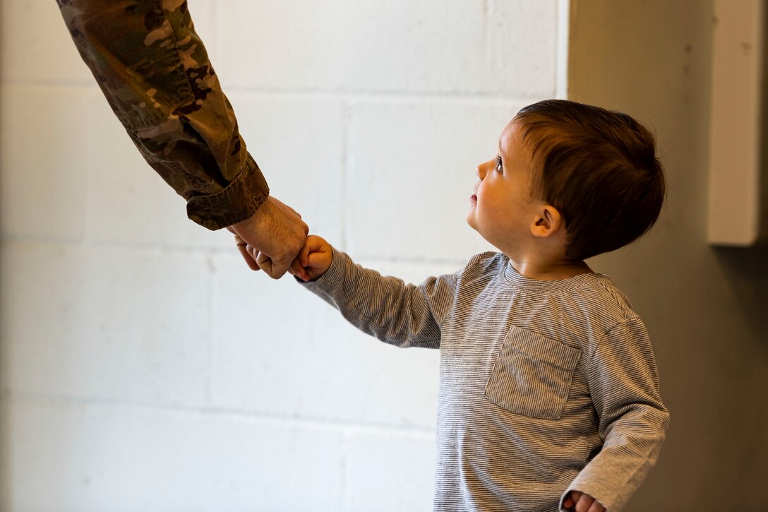Photo of child greeting an Airman.