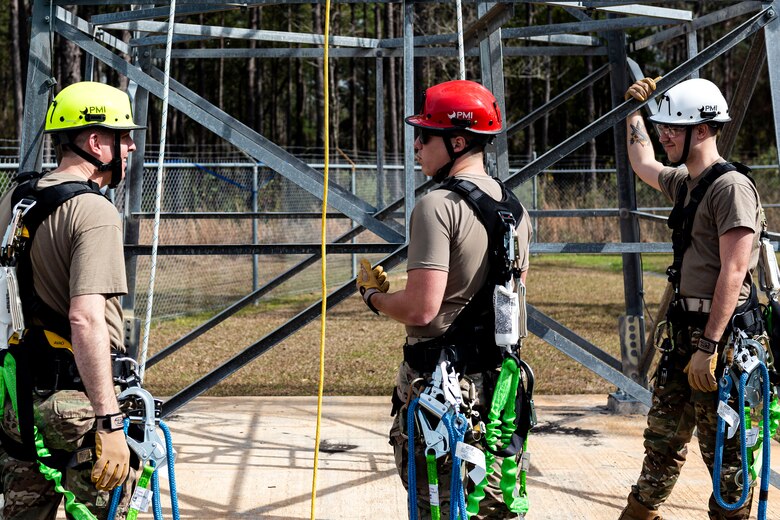 Photo of Airmen discussing climbing procedures.