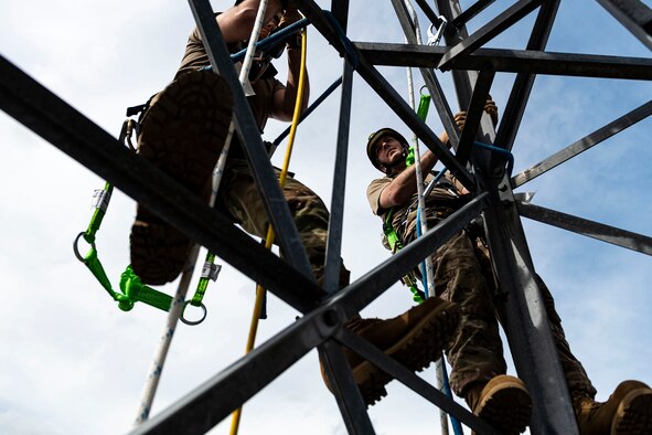 Photo of Airmen discussing rappelling procedures.
