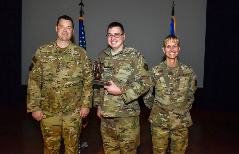 Master Sgt. Kyle Gilbertson (center), 913th Operations Support Squadron, was selected at the group's Senior non commissioned officer of the 2019 annual award period. Col. Dan Collister (left), 913th Airlift Group deputy commander, and Chief Master Sgt. Kimberly Lord, 913th Airlift Group superintendent, hosted an all call to honor the 2019 award winners on Feb. 8, 2020, at Little Rock Air Force Base, Ark. (U.S. Air Force Reserve photo by Senior Airman Nathan Byrnes)