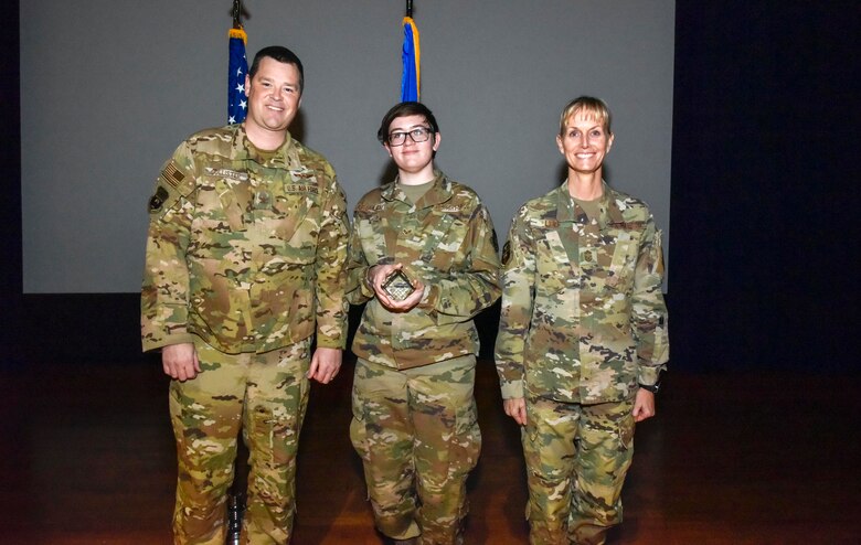 Senior Airman Chloe Lawrence (center), 96th Aerial Port Squadron, was selected at the group's Airmen category of the 2019 semi-annual award period. Col. Dan Collister (left), 913th Airlift Group deputy commander, and Chief Master Sgt. Kimberly Lord, 913th Airlift Group superintendent, hosted an all call to honor the 2019 award winners on Feb. 8, 2020, at Little Rock Air Force Base, Ark. (U.S. Air Force Reserve photo by Senior Airman Nathan Byrnes)