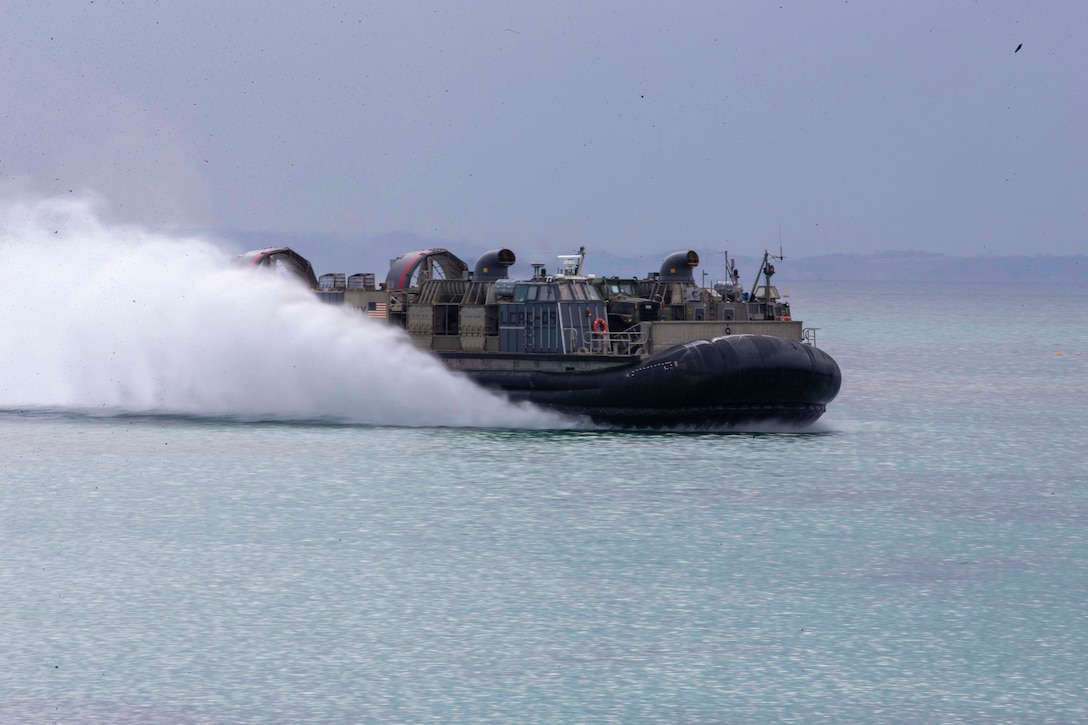 An air-cushioned landing craft travels through waters.