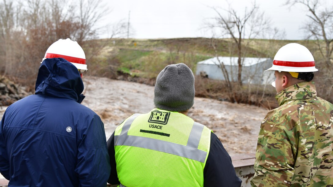 Jamie Bond, Civil Engineer of the Walla Walla Corps of Engineers, informs Lt. Col. Christian Dietz, Commander of the Walla Walla District Corps of Engineers, and Alan Feistner, Deputy District Engineer for the Walla Walla District Corps of Engineers, about water levels in the Walla Walla River in Milton Freewater.