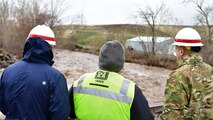Jamie Bond, Civil Engineer of the Walla Walla Corps of Engineers, informs Lt. Col. Christian Dietz, Commander of the Walla Walla District Corps of Engineers, and Alan Feistner, Deputy District Engineer for the Walla Walla District Corps of Engineers, about water levels in the Walla Walla River in Milton Freewater.