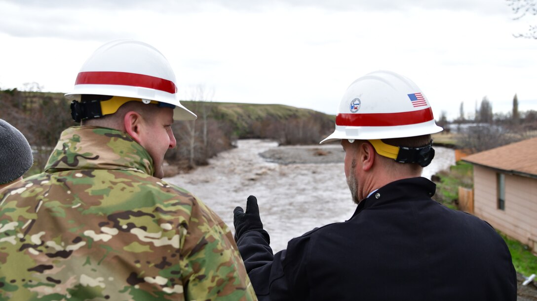 Lt. Col. Christian Dietz, Commander of the Walla Walla District Corps of Engineers, and the District's Chief of Engineering, Dwayne Weston, survey the erosion near Marie Dorion Park in Milton Freewater.