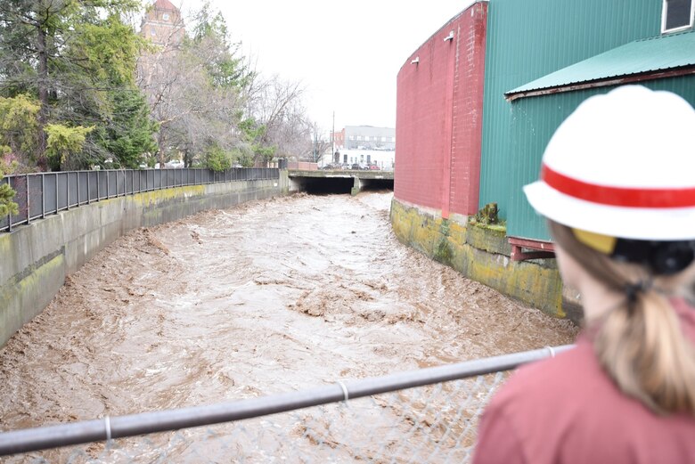 Corps Official recording the flows through the Mill Creek Channel.